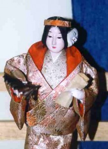 A doll representing a Noh actor with his mask.