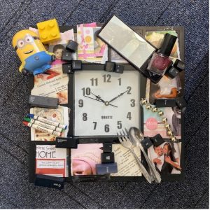 Wall clock surrounded by a collage of objects